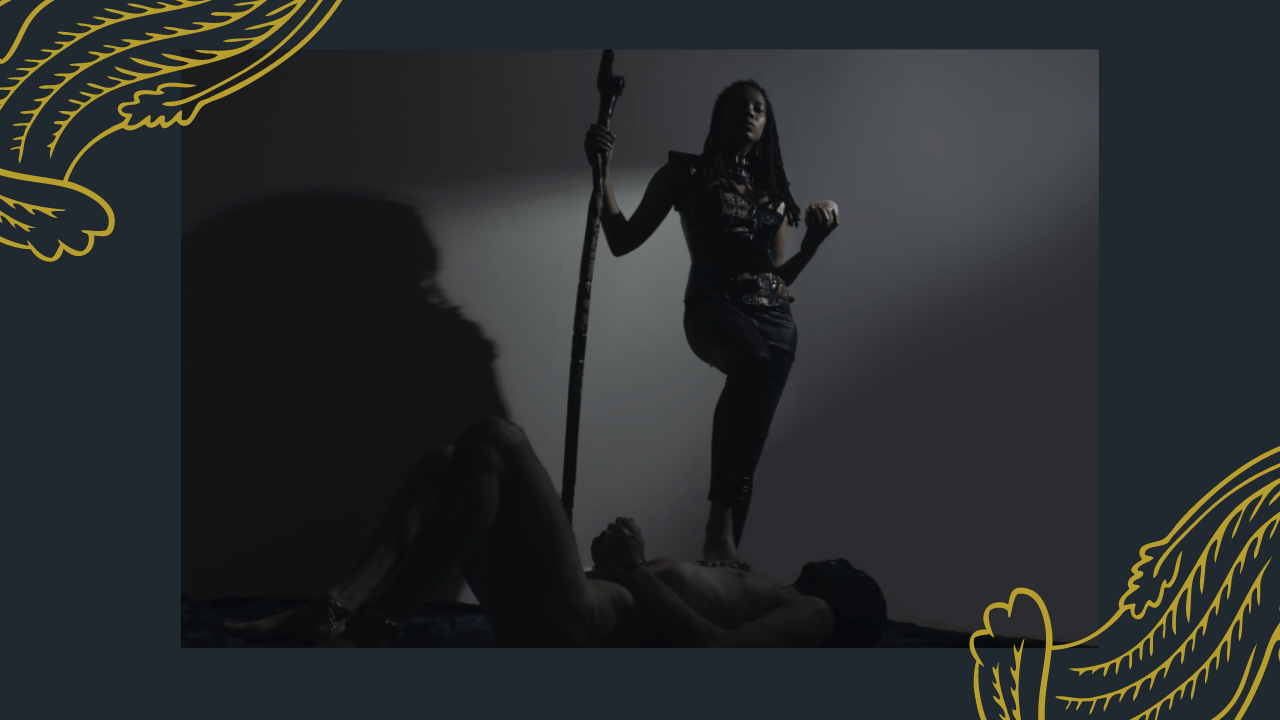A sub is on the floor while Mistress Nicole stands over him
