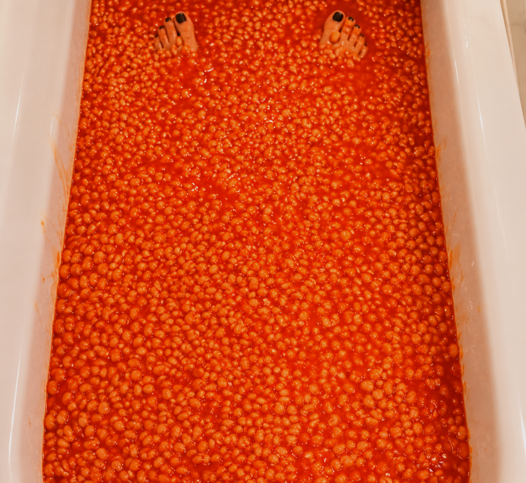 Feet in a bath filled with baked beans for sploshing in London