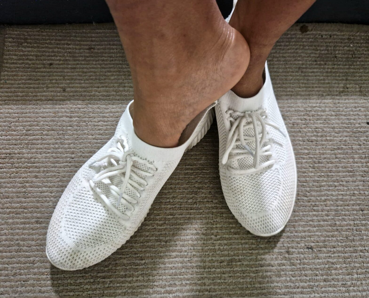 Goddess Nicole wearing trainers without socks for her sweaty feet fetish London article