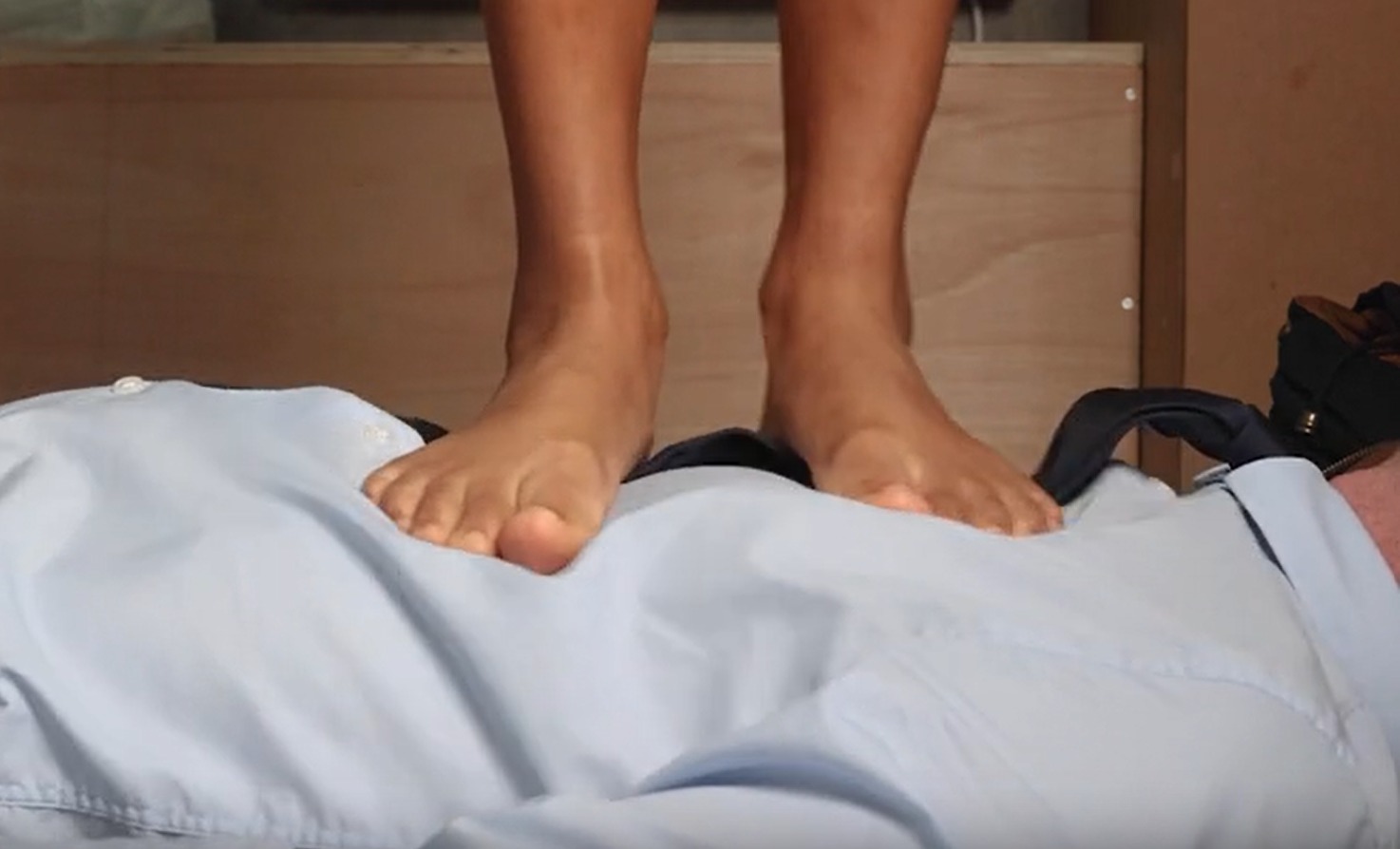 Goddess Nicole stepping on a consenting participant during a foot trampling session in London.